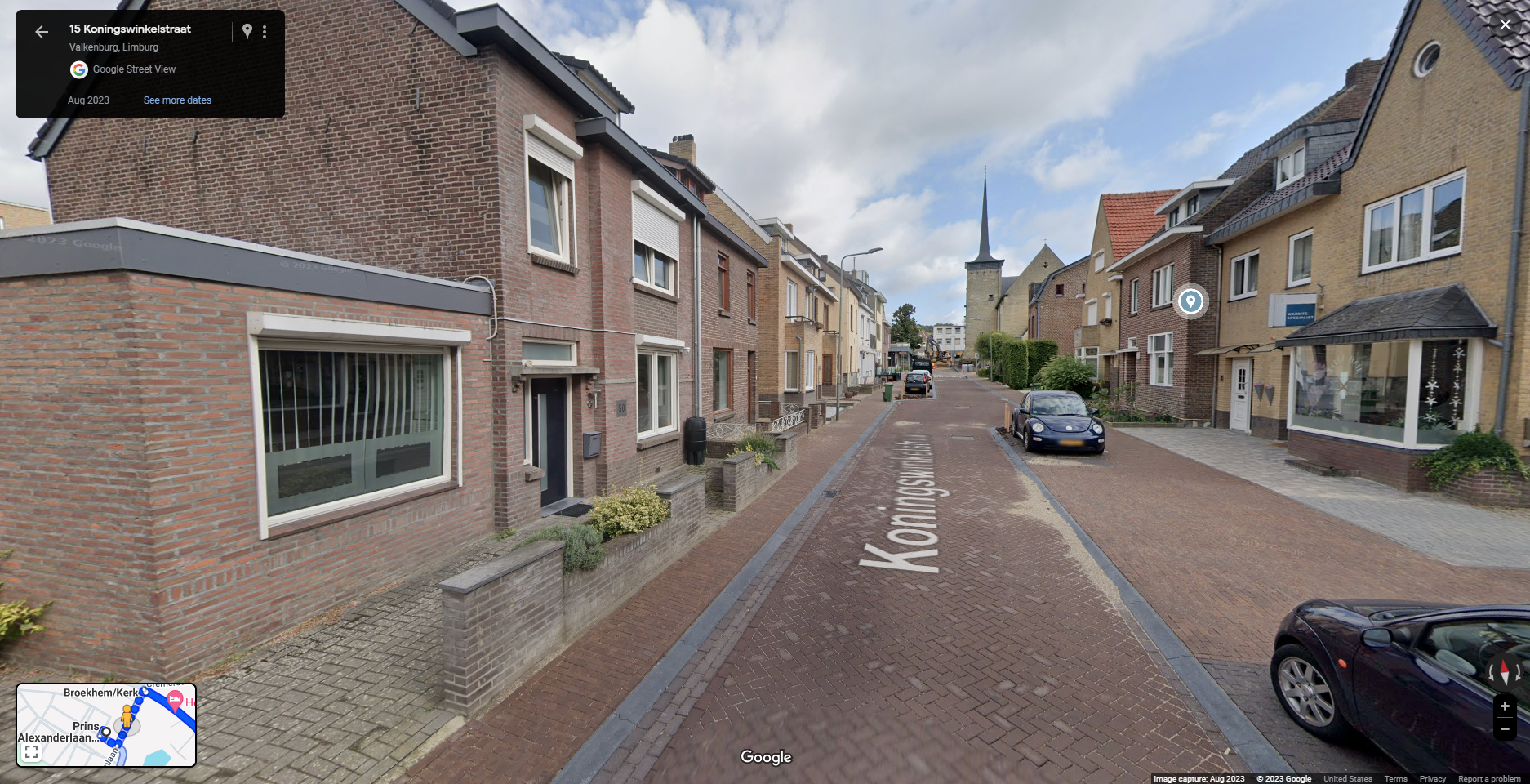 This image shows a Google Street View capture from August 2023 of 15 Koningswinkelstraat in Valkenburg, Limburg, Netherlands. The view showcases a narrow brick-paved street lined with residential houses on both sides. Several houses have small front gardens or brick planters, and cars are parked along the street. In the distance, a tall church steeple is visible, marking a prominent landmark. The map inset at the bottom-left corner shows the location in relation to nearby streets. The setting is quiet, reflecting a typical residential street in a European town.